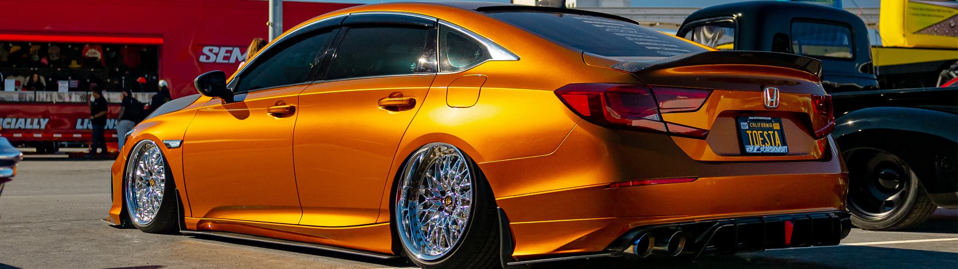 A copper lowered vehcile in front of the SEMA building in Las Vegas.